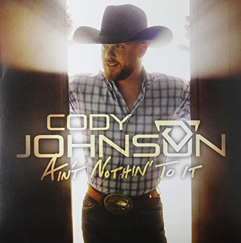 Cody Johnson album cover, a man in a cowboy hat smiling.