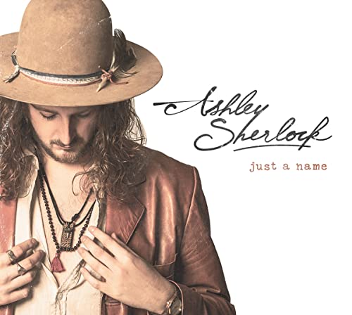 CD cover featuring a man with long hair and a brown hat.