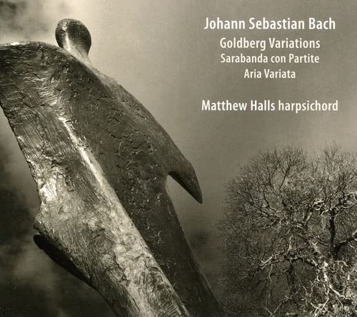 CD cover: abstract sculpture against a cloudy sky with text.