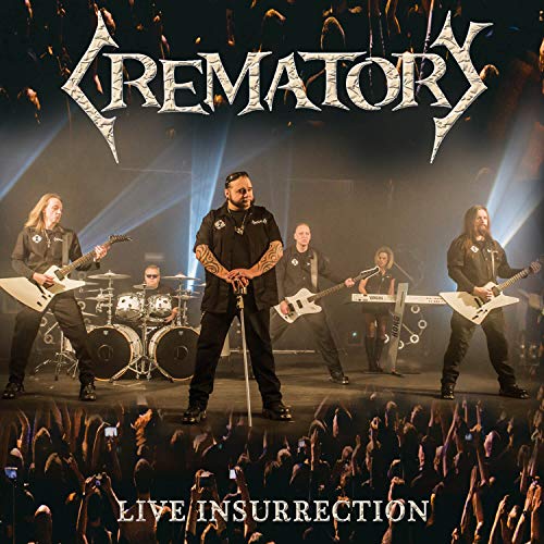 Metal band Crematory performing live on stage with a crowd.