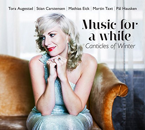 CD cover: woman in silver dress seated on a brown couch.
