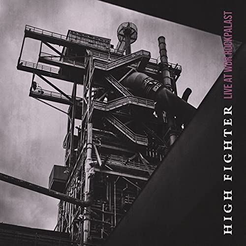 A black and white image of an industrial steel structure with text on the side.