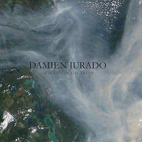 Album cover for Damien Jurado’s “Caught In The Trees” with aerial view.