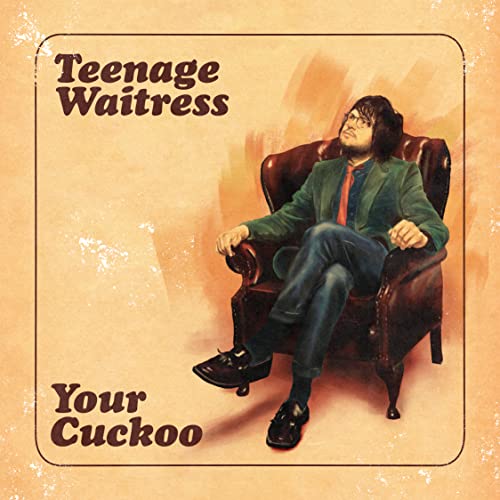 Album cover: man in suit sits in a brown leather armchair.
