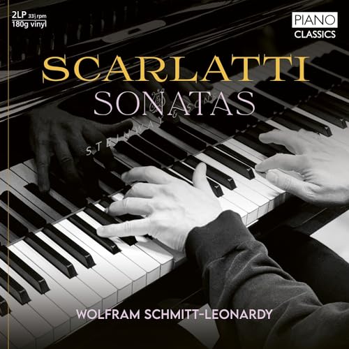Close-up of hands playing a piano on a black and white vinyl album cover.