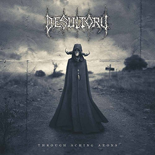 Hooded figure with horns stands in a desolate, foggy landscape.