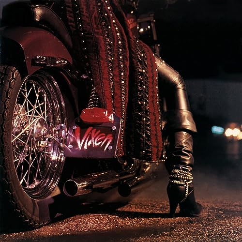 Motorcycle with a person wearing leather and embellished boots.