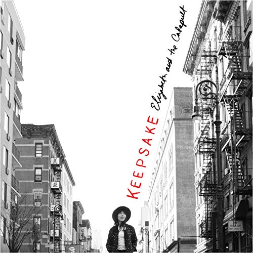 Black and white CD cover with a woman standing on a city street.