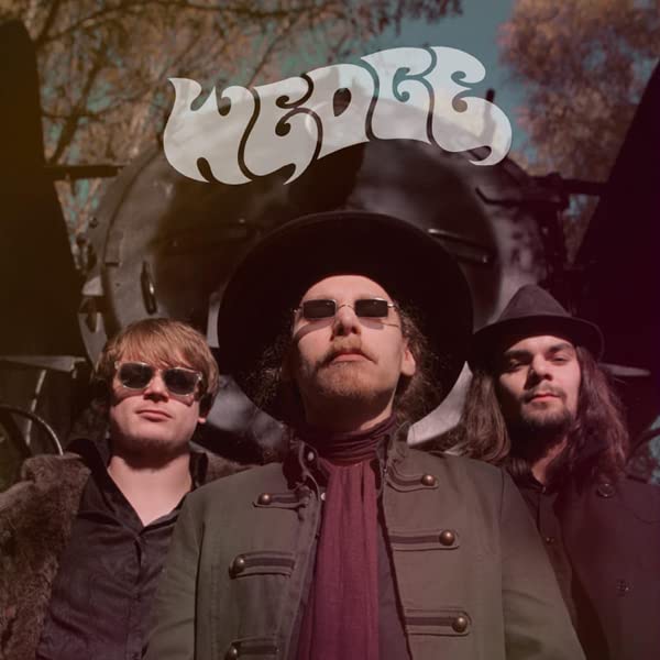 Album cover for "Wedge" featuring three men in sunglasses and hats.