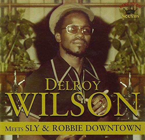 CD cover featuring Delroy Wilson in glasses, with gold lettering.