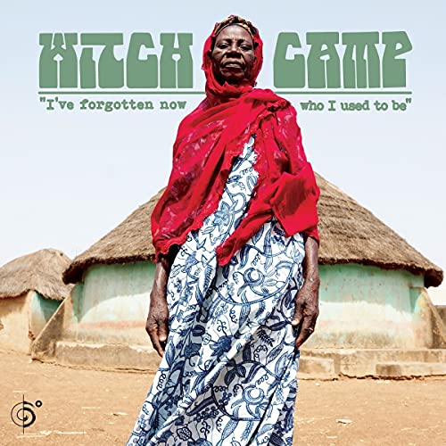 Vinyl album cover featuring a woman in red and blue, rural background.