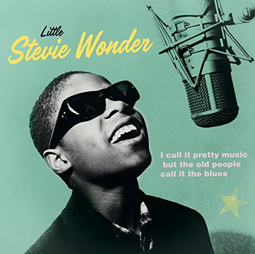 Black and white portrait of Stevie Wonder with a vintage microphone.