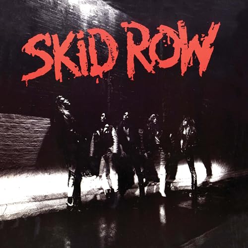 The band Skid Row stands in a dark alley beneath their red logo.