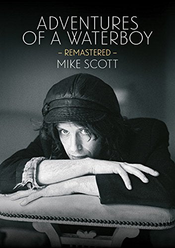 Book cover: man with long hair looking down, wearing a cap.
