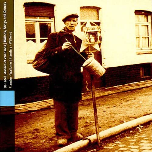 Sepia-toned photo of a man with a musical instrument and lantern.