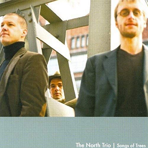 CD cover featuring three men against an urban, industrial backdrop.
