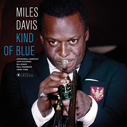 Miles Davis holding a trumpet, album cover for “Kind of Blue”.