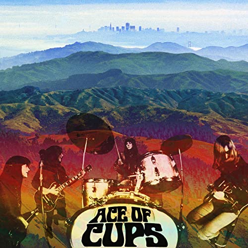 1960s band Ace Of Cups in front of a hilly, city landscape.