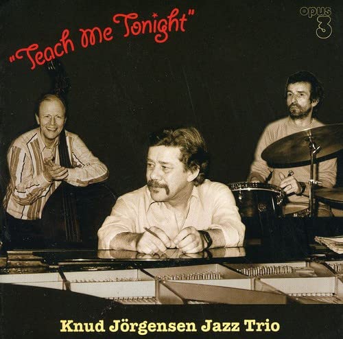 Jazz trio with piano, bass, and drums, album cover for "Teach Me Tonight".