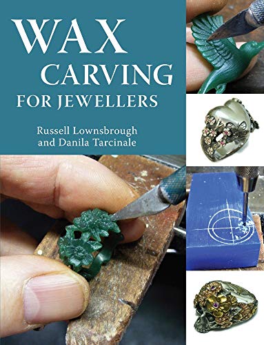 Book with carving tools and wax blocks, likely on a workbench or similar surface.