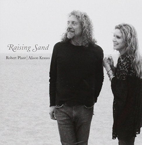 Black and white album cover featuring Robert Plant and Alison Krauss standing on sand.