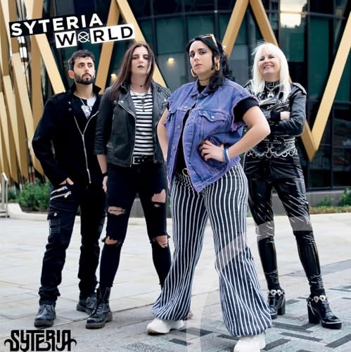 Four people posing outdoors in front of a geometric building.