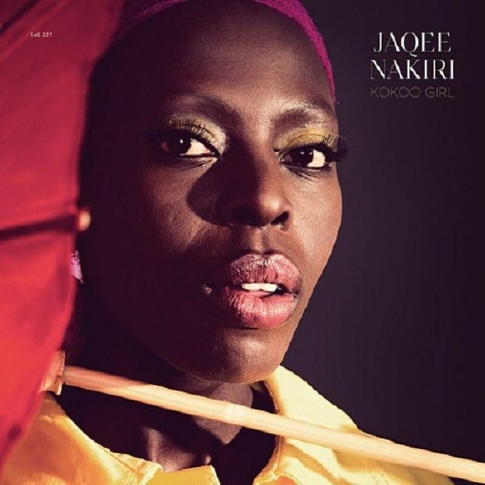 Close-up portrait of Jaqee Nakiri, a dark-skinned woman with gold eyeshadow.