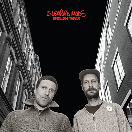 Black and white album cover featuring two men in front of buildings.