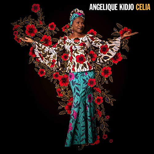 Angelique Kidjo in patterned clothing with floral wing designs.