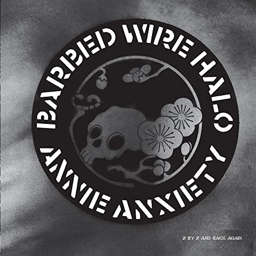 Black and white album cover with skull, flowers, and circular text.