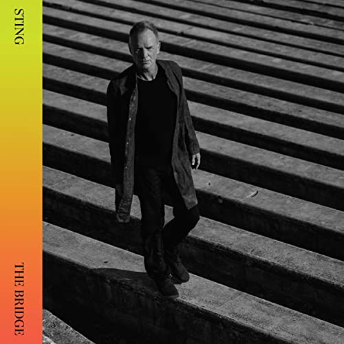 Sting stands on concrete steps, album cover for “The Bridge.”