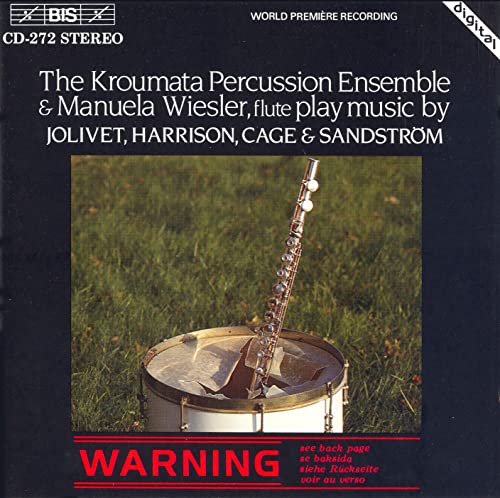 CD cover: a flute resting on a drum in a grassy field.