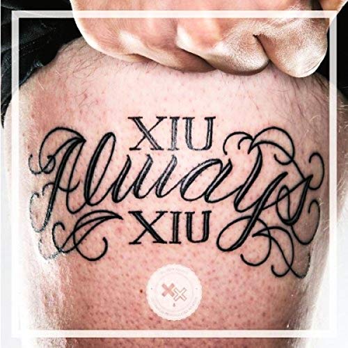 A close-up of a tattoo on skin reading Xiu Always Xiu in cursive script.