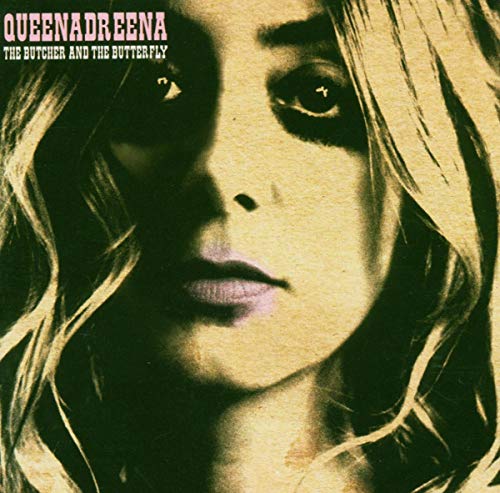 CD cover: close-up of a woman’s face with dark makeup and blonde hair.