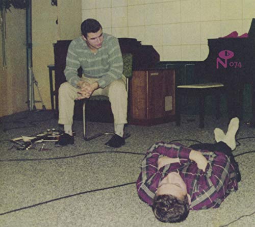 CD cover: two people in a room, one lying down, one seated.