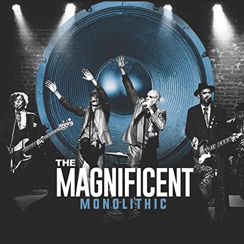 Band performing in front of a large blue speaker, album cover.