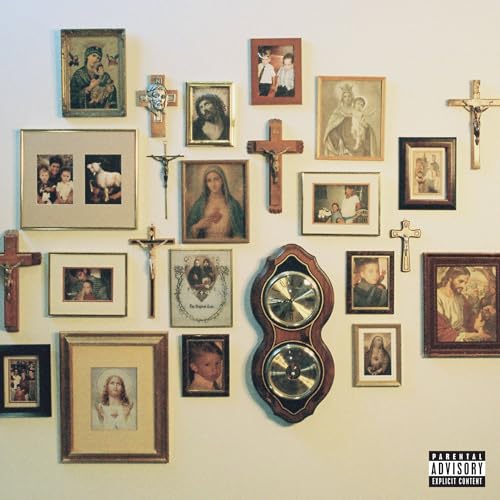 Wall of religious imagery and portraits surrounding a dual CD player.