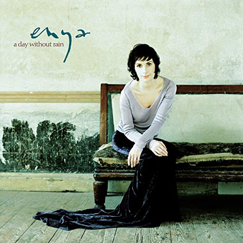 Enya album cover: woman seated on a weathered bench, misty landscape.