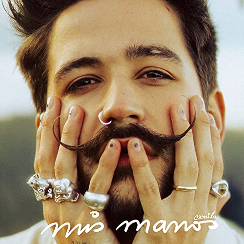 Camilo album cover: close-up of artist with hands framing his face.