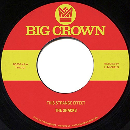 Red and yellow vinyl record label with text: "The Shacks - This Strange Effect".