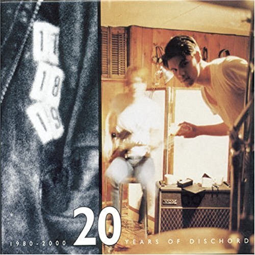CD box set cover with a man near a guitar and amplifier.