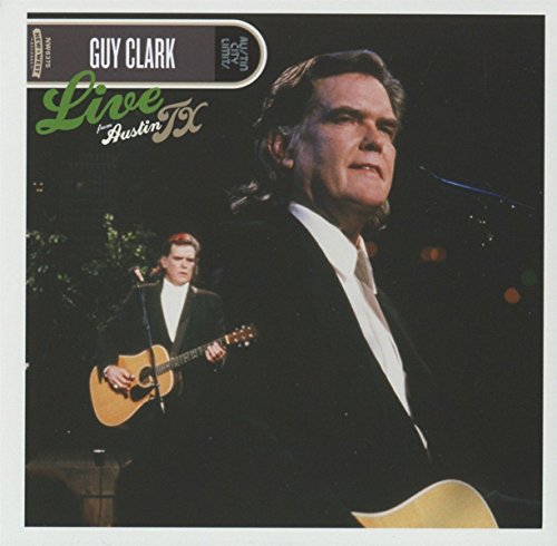 Guy Clark performing live with a guitarist on stage.