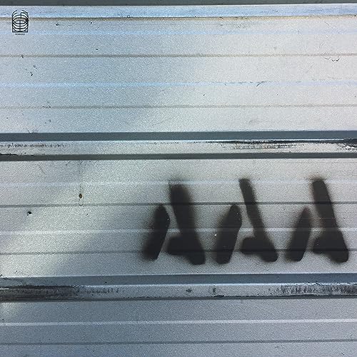 Spray-painted black symbols on a horizontal, silver-grey corrugated metal surface.