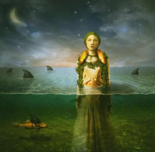 Woman submerged in water with sharks and a crescent moon.