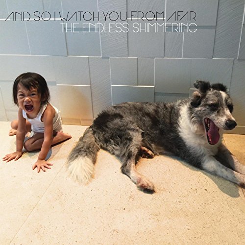 Album cover: child and dog with open mouths on tiled floor.