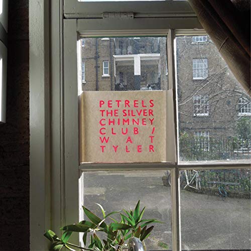 Vinyl record cover with red text against a window backdrop.