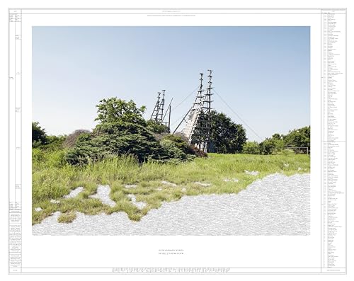 Green field with tall metal communication towers under a clear blue sky.
