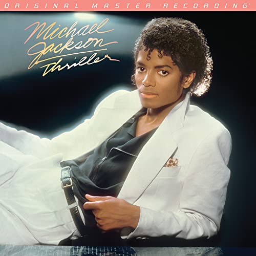 Michael Jackson’s “Thriller” album cover featuring him in a white suit.