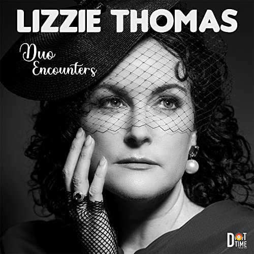 Black and white portrait of Lizzie Thomas wearing a hat and veil.