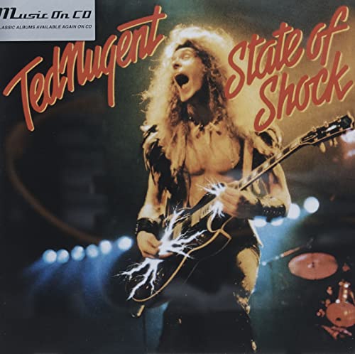 Ted Nugent with long hair screaming while playing an electric guitar on stage.